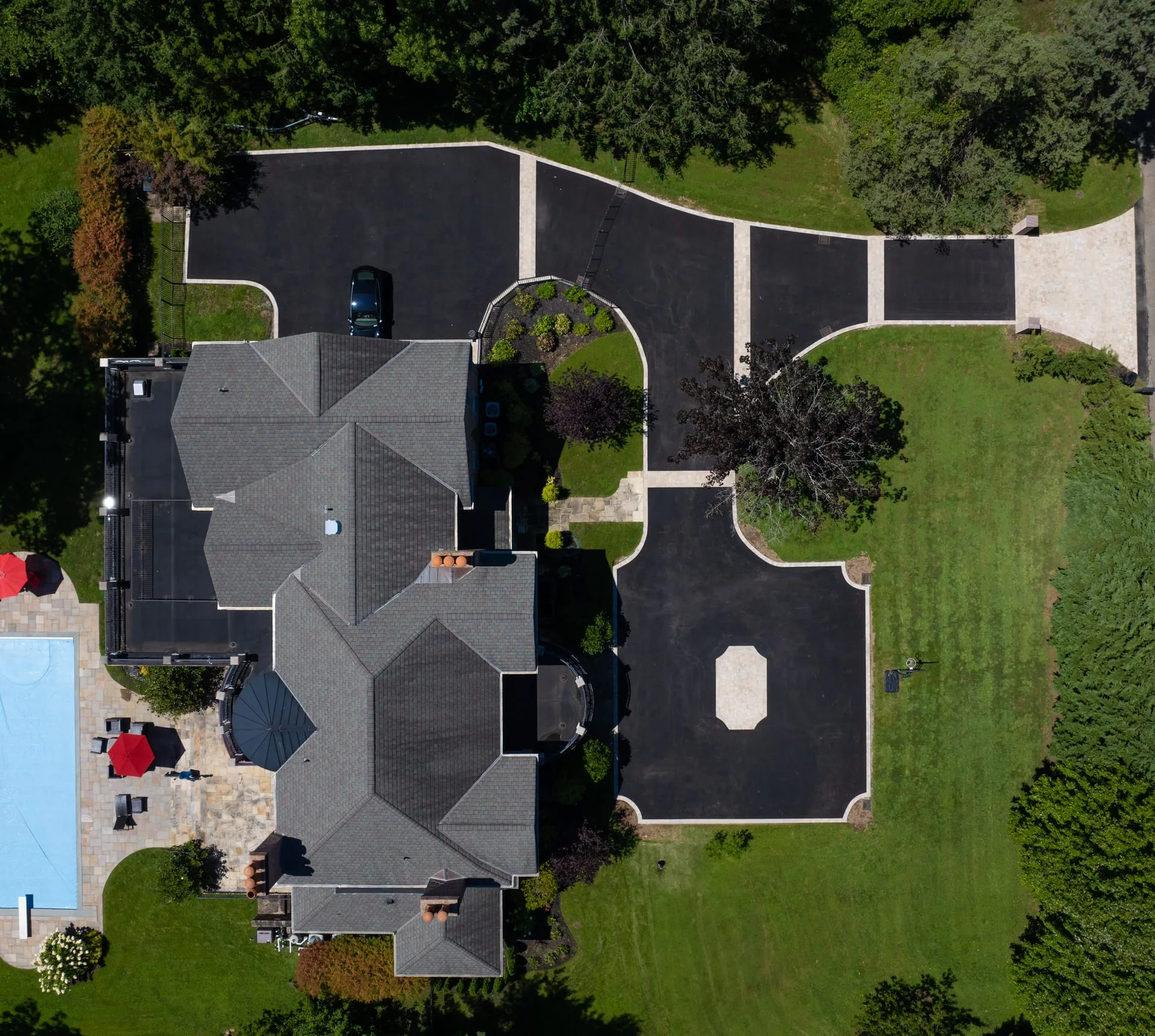Overhead drone shot showing full T-shaped estate driveway system in Lloyd Harbor