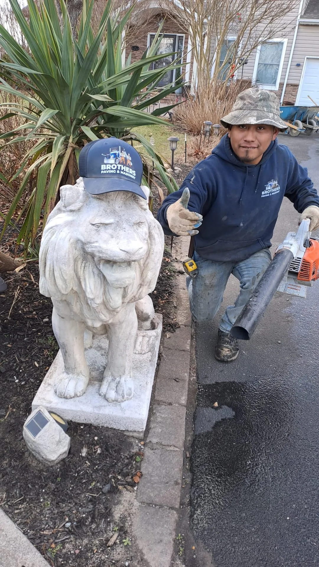 Crew member with Brothers Paving cap giving thumbs up
