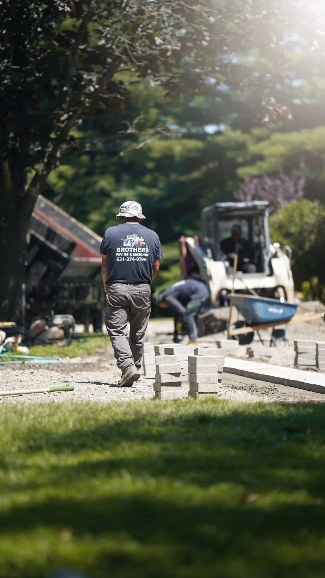 Brothers Paving crew member walking toward active jobsite